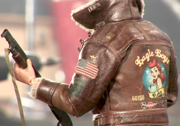 The goof-ball American fighter pilot was another waste of time, predictable and completely unfunny. However, the back of his jacket revealed some nice detailing work, unlike the front, which was a hodgepodge of pilot's pins and other silliness. (Photo: Flatiron Film Co.)